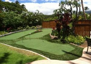 Southwest Greens fake grass yard with synthetic turf putting area and surrounding landscape